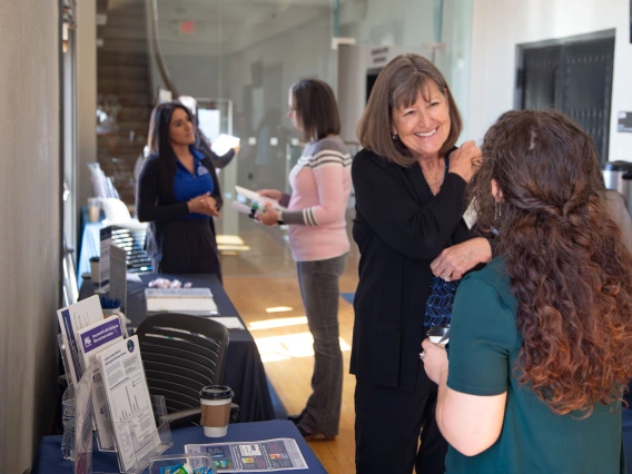Nancy Johnson talks with a student