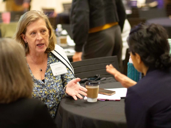Erin McMahon talks with Nancy Johnson and Salma Patel