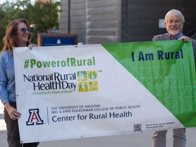 Jill Bullock and Dan Derksen with National Rural Health Day sign