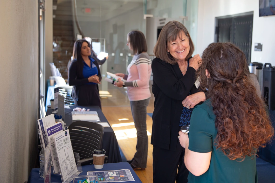 Nancy Johnson talks with a student