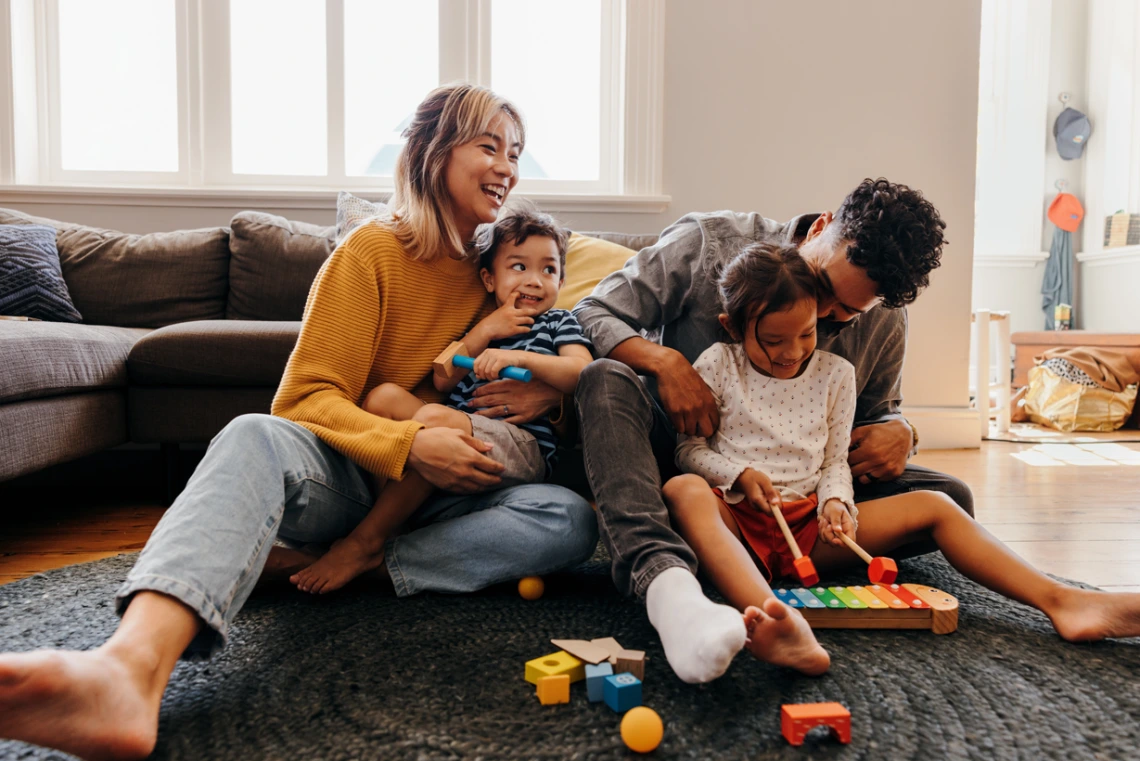 young family playing on the floor