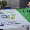 Jill Bullock and Dan Derksen with National Rural Health Day sign